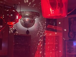 A photo of our mirror ball reflecting the red lights inside our showroom